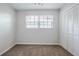 Bedroom featuring neutral carpet, a window, and a closet at 5847 Harrison St, New Port Richey, FL 34653