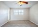 Inviting bedroom featuring carpet flooring, a ceiling fan, and a bright window at 5847 Harrison St, New Port Richey, FL 34653