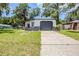 Charming single-story home featuring a convenient attached garage and fresh landscaping at 5847 Harrison St, New Port Richey, FL 34653