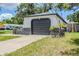 Attached garage offers convenience and functionality, complemented by lush landscaping at 5847 Harrison St, New Port Richey, FL 34653
