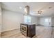Open floor plan showcases kitchen island with modern range hood and light wood flooring at 5847 Harrison St, New Port Richey, FL 34653