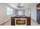 Kitchen island featuring a stainless oven, cooktop, and eat in dining space at 5847 Harrison St, New Port Richey, FL 34653
