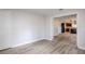 Spacious living room features light wood flooring and access to a modern kitchen at 5847 Harrison St, New Port Richey, FL 34653