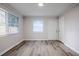 Room featuring plank flooring and a window at 5847 Harrison St, New Port Richey, FL 34653