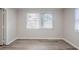 Room featuring plank flooring and a window at 5847 Harrison St, New Port Richey, FL 34653