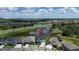 A beautiful aerial view of a home in a quiet neighborhood with nearby lakes and green spaces at 5971 Hidden Branch Dr, Apollo Beach, FL 33572