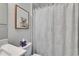 Bright bathroom with a shower/tub combo, single sink vanity, and a framed art print at 5971 Hidden Branch Dr, Apollo Beach, FL 33572