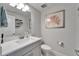 Bathroom with a modern vanity, stylish mirror, and coastal-themed decor, creating a fresh and inviting space at 5971 Hidden Branch Dr, Apollo Beach, FL 33572
