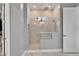 Bathroom shower with glass walls, shower head, wall niche and a towel rack at 5971 Hidden Branch Dr, Apollo Beach, FL 33572