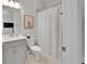 Bright bathroom with a shower/tub combo, single sink vanity, and a framed art print at 5971 Hidden Branch Dr, Apollo Beach, FL 33572