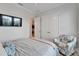 Bedroom with a mounted TV, closet and decorative chair offering a blend of function and style at 5971 Hidden Branch Dr, Apollo Beach, FL 33572