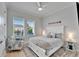 Bright bedroom with large window, ceiling fan, and accent chair, creating a comfortable and inviting space at 5971 Hidden Branch Dr, Apollo Beach, FL 33572