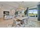 Light and bright dining room overlooking the pool with modern light fixture and an open floorplan at 5971 Hidden Branch Dr, Apollo Beach, FL 33572