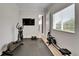 Fully equipped home gym with exercise equipment and natural light at 5971 Hidden Branch Dr, Apollo Beach, FL 33572