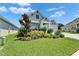 Beautiful home exterior featuring a brick driveway, a garage, and colorful landscaping on a sunny day at 5971 Hidden Branch Dr, Apollo Beach, FL 33572