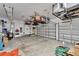 Spacious garage with overhead storage racks, organized tool storage, and ample room for vehicles and projects at 5971 Hidden Branch Dr, Apollo Beach, FL 33572