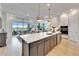 Bright, open-concept kitchen with a large island, pendant lighting, and a spacious living area at 5971 Hidden Branch Dr, Apollo Beach, FL 33572