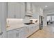 Bright kitchen with stainless steel appliances, white cabinetry and modern backsplash at 5971 Hidden Branch Dr, Apollo Beach, FL 33572