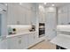 White kitchen featuring modern cabinetry, stainless appliances, and bright countertop at 5971 Hidden Branch Dr, Apollo Beach, FL 33572