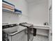 Functional laundry room featuring modern washer and dryer, counter space, and ample shelving for storage at 5971 Hidden Branch Dr, Apollo Beach, FL 33572