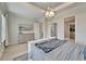 Spacious main bedroom featuring a tray ceiling with a modern chandelier and access to walk-in closet at 5971 Hidden Branch Dr, Apollo Beach, FL 33572