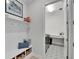 Well-organized mud room with storage bench, hooks, and stylish patterned flooring, perfect for keeping tidy at 5971 Hidden Branch Dr, Apollo Beach, FL 33572