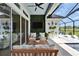 Inviting covered patio with a lush green wall and stylish outdoor furniture, perfect for relaxation at 5971 Hidden Branch Dr, Apollo Beach, FL 33572