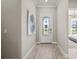 Inviting entryway with a decorative glass front door and sidelights, leading into a modern home at 6162 Winding Pine Dr, Nokomis, FL 34275