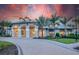 Beautiful clubhouse exterior featuring classic architecture, arched entryways, and lush landscaping at 6162 Winding Pine Dr, Nokomis, FL 34275