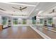 Bright fitness room featuring ceiling fans, wall-mounted mirrors, and workout equipment at 6162 Winding Pine Dr, Nokomis, FL 34275