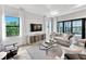 Well-lit living room with shiplap accents and a wall of windows, creating a welcoming space at 6162 Winding Pine Dr, Nokomis, FL 34275