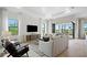 Bright living room with shiplap accent wall, recessed lighting, and sliding glass doors at 6162 Winding Pine Dr, Nokomis, FL 34275
