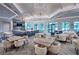 Clubhouse lounge area with comfortable seating, elegant tables, and a stylish bar area for socializing at 6162 Winding Pine Dr, Nokomis, FL 34275
