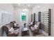 Sitting room featuring white ship lap walls, designer chandelier and comfortable seating at 6162 Winding Pine Dr, Nokomis, FL 34275