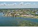 Scenic aerial perspective of a coastal town with beach, marina, and waterfront activities at 6531 Seaview Blvd, Hudson, FL 34667
