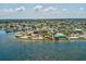 Wide aerial view of charming coastal town with lush greenery, marina and beautiful waterfront at 6531 Seaview Blvd, Hudson, FL 34667