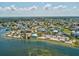 Panoramic aerial shot showcasing a coastal community with a marina, waterfront homes, and lush landscaping at 6531 Seaview Blvd, Hudson, FL 34667