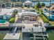 Aerial view of waterfront home featuring a screened-in lanai, boat dock, and outdoor dining at 6531 Seaview Blvd, Hudson, FL 34667