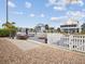 Waterfront backyard with brick pavers, patio seating area, a boat dock and tropical foliage at 6531 Seaview Blvd, Hudson, FL 34667