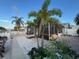 Waterfront backyard with lush tropical plants, paver patio, and screened-in lanai for outdoor enjoyment at 6531 Seaview Blvd, Hudson, FL 34667