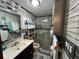 Bathroom featuring modern vanity, a glass shower enclosure, and decorative tile walls at 6531 Seaview Blvd, Hudson, FL 34667