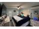 A cozy bedroom features a queen bed, ceiling fan, and plantation shutters at 6531 Seaview Blvd, Hudson, FL 34667