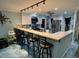 Modern kitchen featuring a long bar counter with stylish stools and lots of storage space at 6531 Seaview Blvd, Hudson, FL 34667