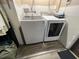 Laundry room features white, front-loading Samsung washer and dryer at 6531 Seaview Blvd, Hudson, FL 34667