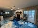 Comfortable living room featuring an electric fireplace, sliding doors to the lanai and striking epoxy flooring at 6531 Seaview Blvd, Hudson, FL 34667