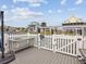 Waterfront home featuring an outdoor kitchen with sink, grey wood flooring and white picket fence at 6531 Seaview Blvd, Hudson, FL 34667
