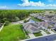 Aerial view of a well-manicured home surrounded by a lush lawn and mature trees, adjacent to a scenic pond at 6606 Pullen Ct, Tampa, FL 33625