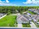 Aerial view of a well-maintained home with a lush green lawn and mature trees creating a peaceful setting at 6606 Pullen Ct, Tampa, FL 33625