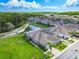 Aerial view of a home and its landscaped surroundings, including a pond and lush greenery at 6606 Pullen Ct, Tampa, FL 33625