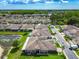 Aerial view of the neighborhood showcases well-maintained homes, landscaping, and a serene pond at 6606 Pullen Ct, Tampa, FL 33625